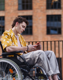 Person in wheelchair looking at a phone