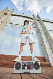Person with boombox on wooden platform